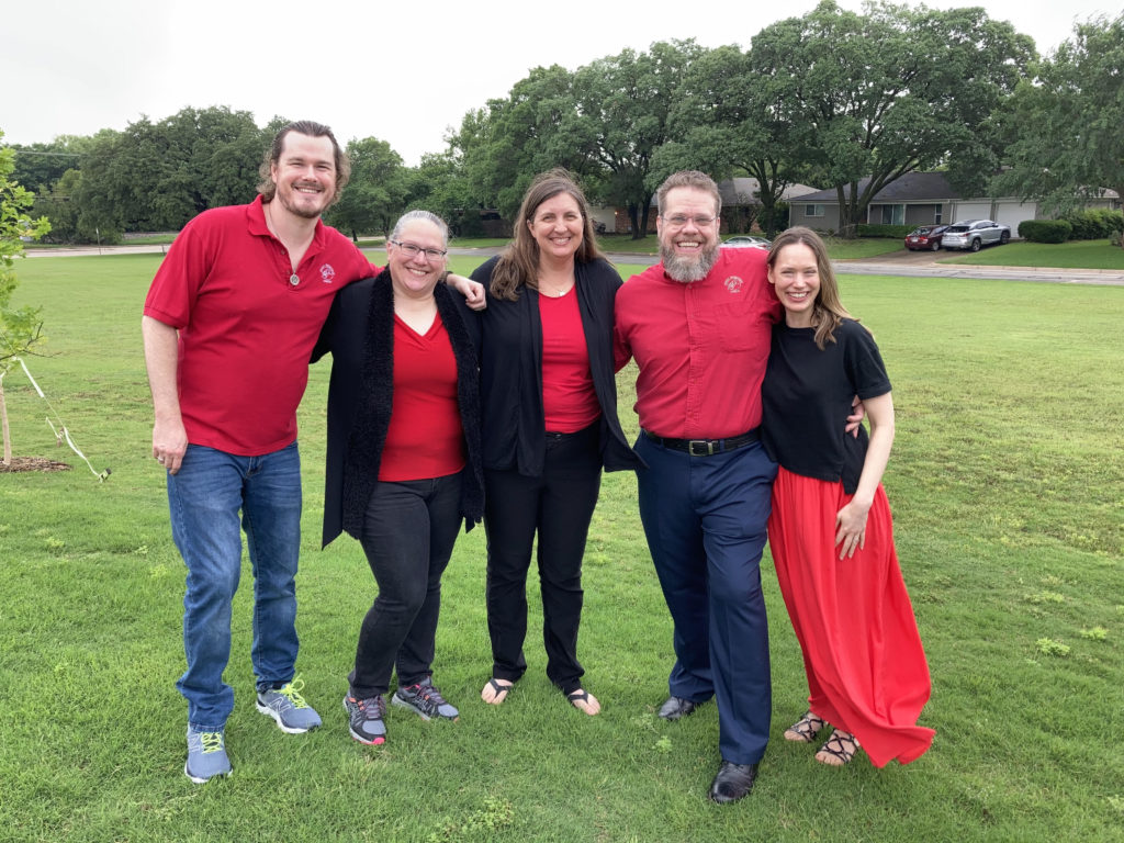 Praise band members standing on the lawn outside the church.